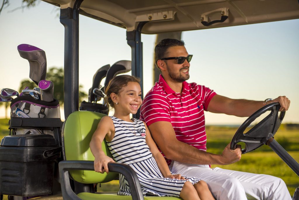 Father and Daughter In Golf Cart